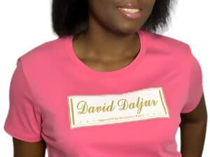 A woman wearing a pink shirt with the name of david saljas on it.