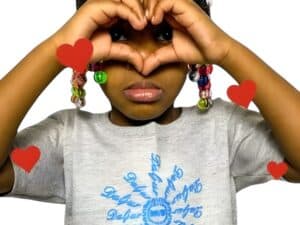 A girl making a heart with her hands