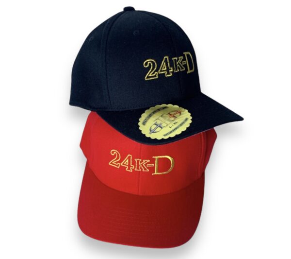 A black and red hat with the words " 2 4 / 7 " on it.