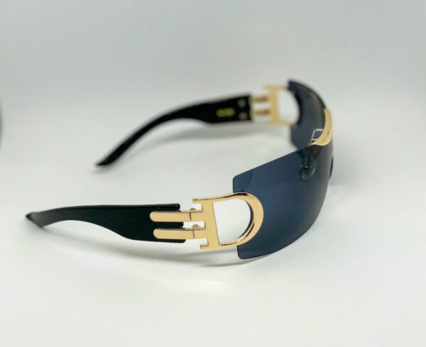 A pair of sunglasses with gold accents on top.