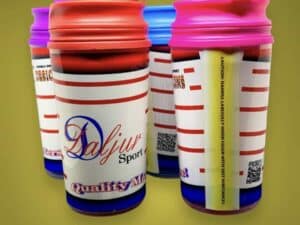 A group of coffee cups with different colored lids.