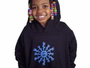 A young girl wearing a black hoodie with beads on the hood.