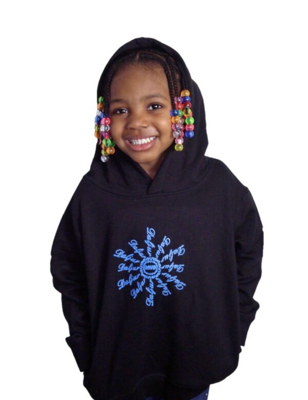 A young girl wearing a black hoodie with beads on the hood.