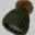 A green hat with a brown pom-pom on top of it.